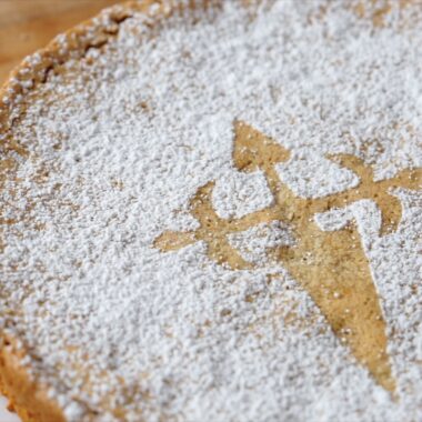 spanish almond cake, decorated with powdered sugar and St.James cross on top